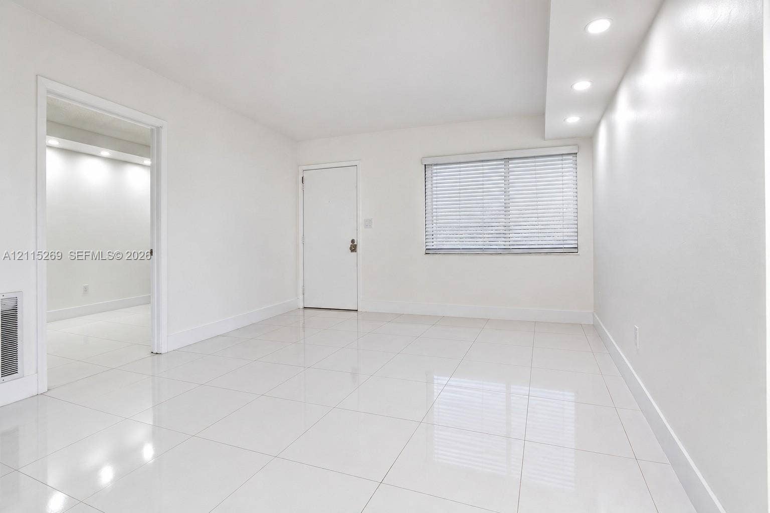 8615 NW 8th Street, #211, Miami, Miami, FL 33126 Interior space featuring polished tile flooring, recessed ceiling lighting, and horizontal window blinds