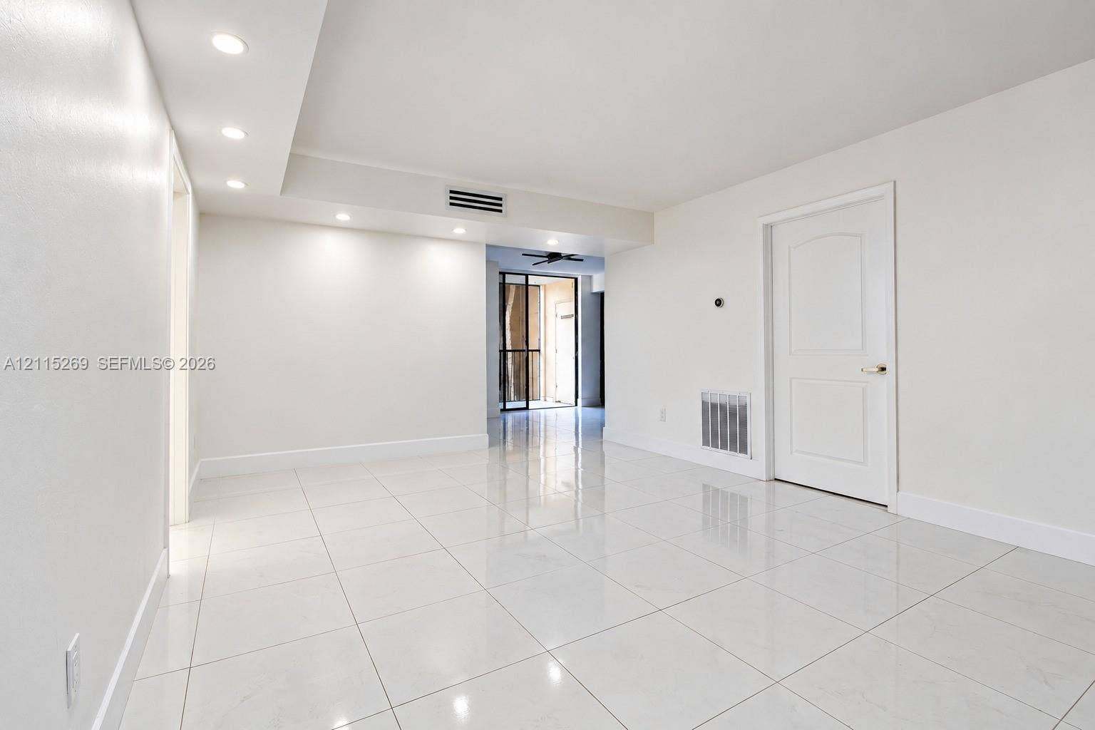 8615 NW 8th Street, #211, Miami, Miami, FL 33126 Large-format tile flooring, recessed ceiling lighting, and a solid-core interior door with polished hardware