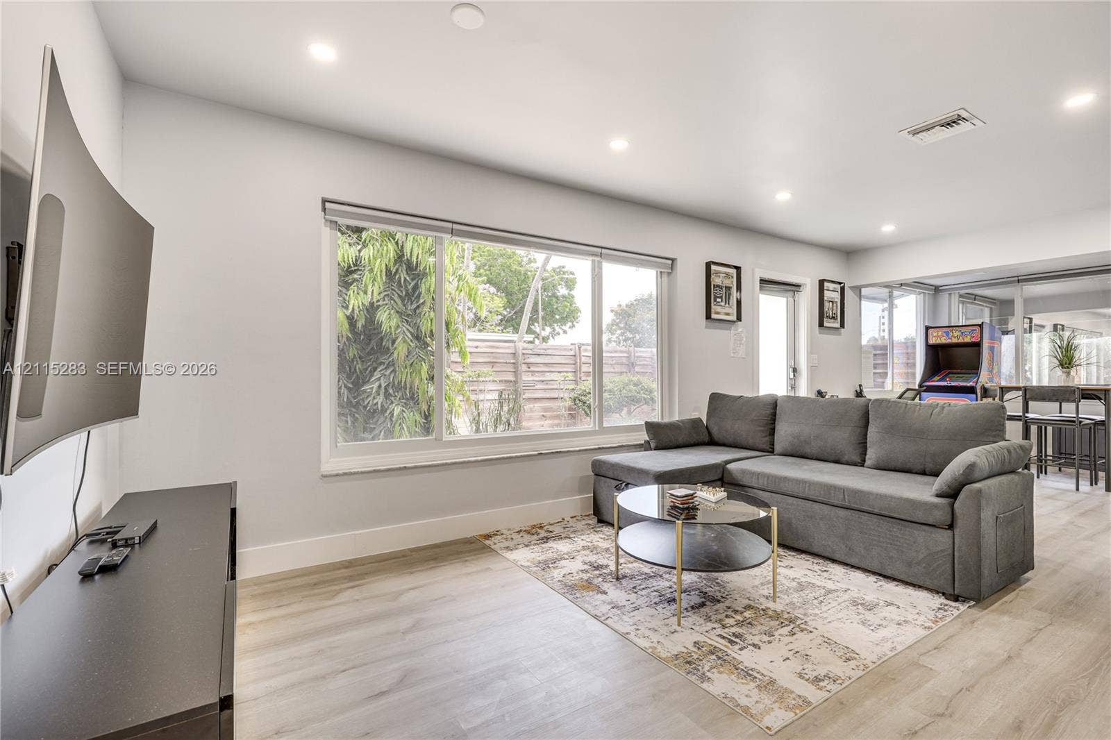 1619a NE 25th Street, #A, Wilton Manors, Wilton Manors, FL 33305 Neutral-toned interior featuring wood-finish flooring, recessed lighting, and a large picture window