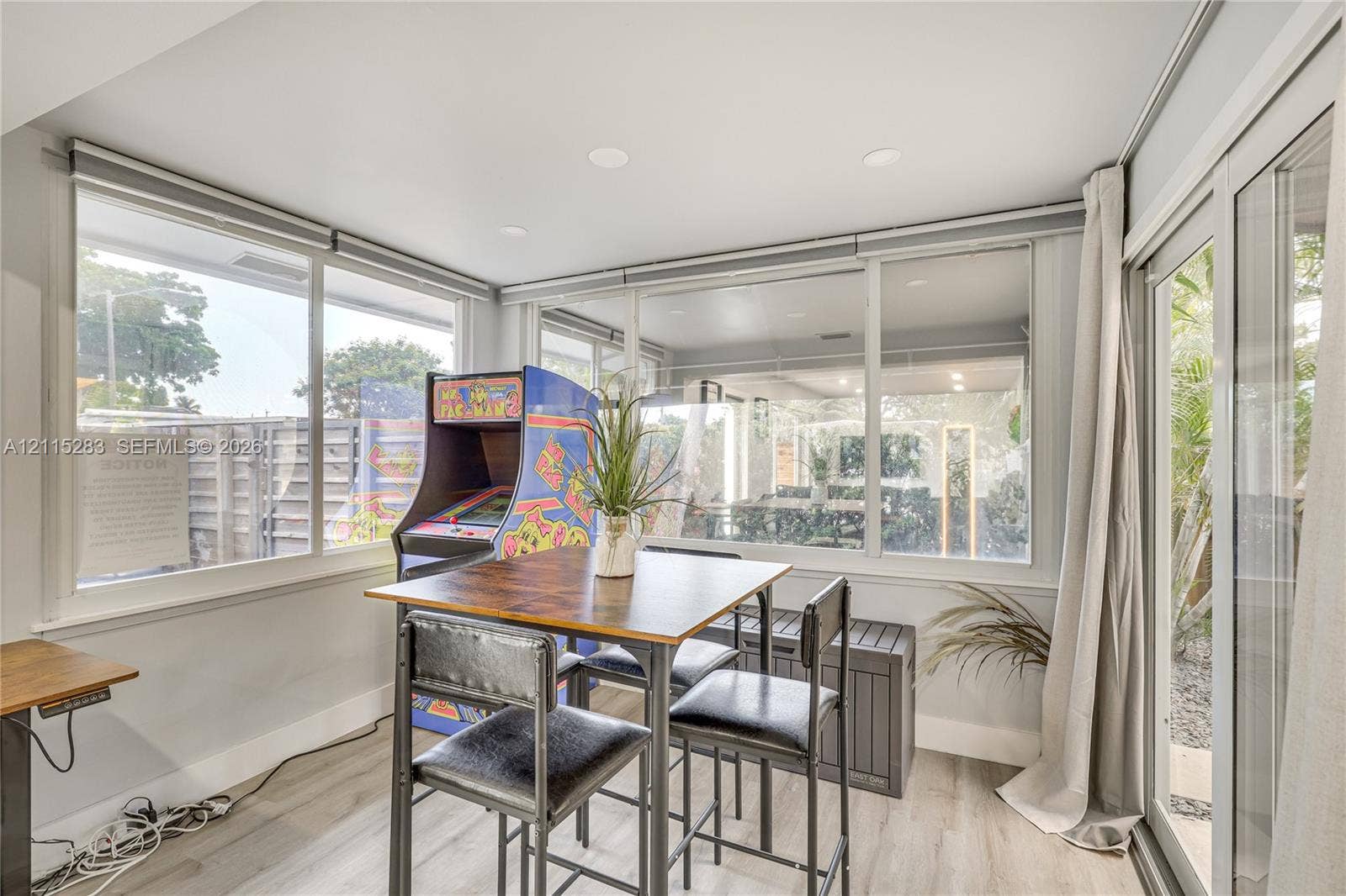 1619a NE 25th Street, #A, Wilton Manors, Wilton Manors, FL 33305 Sunroom featuring expansive windows, recessed lighting, and wood-finish flooring with sliding glass door access to the exterior