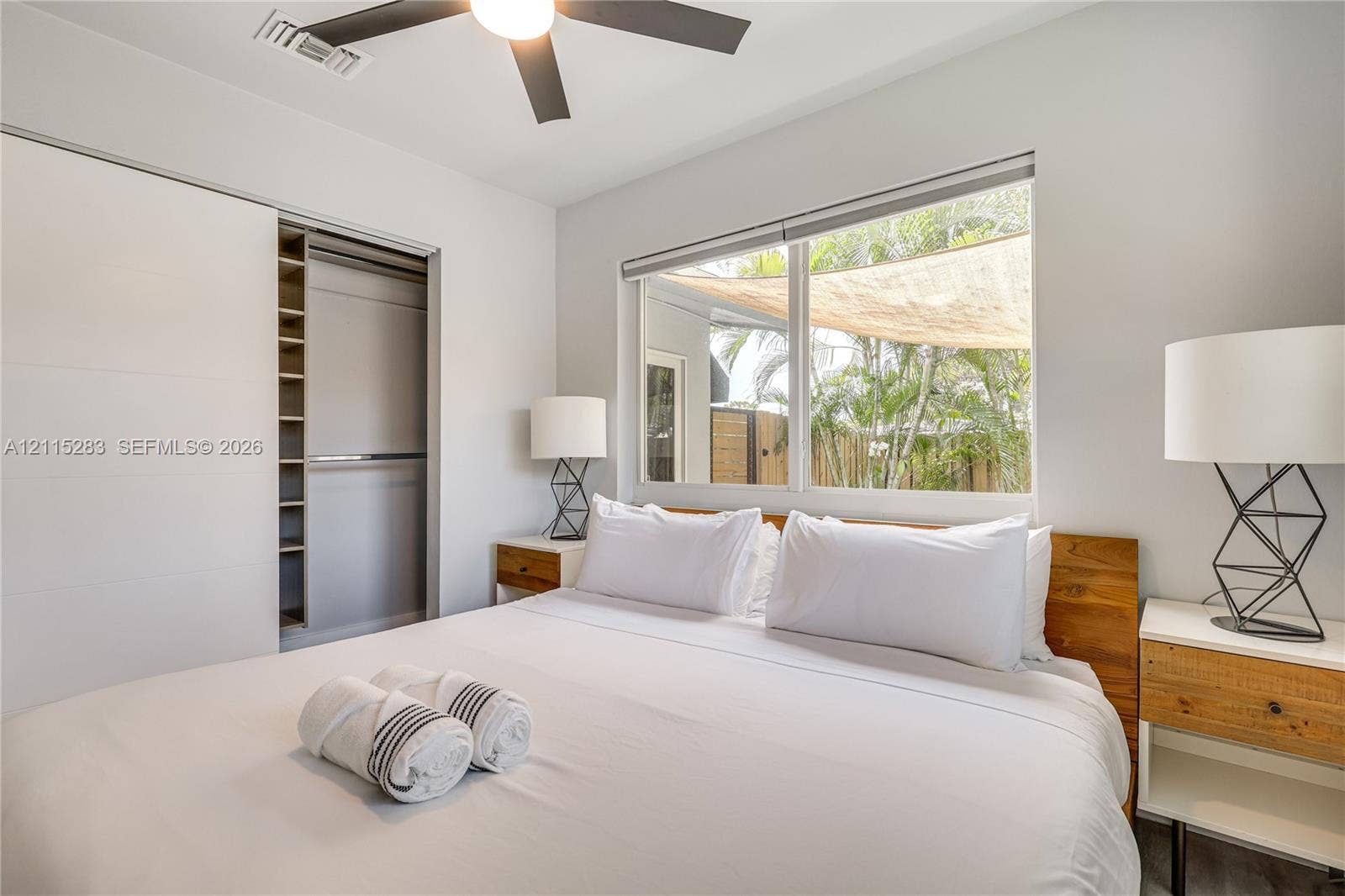 1619a NE 25th Street, #A, Wilton Manors, Wilton Manors, FL 33305 Built-in closet with shelving, large-format window, and ceiling fan