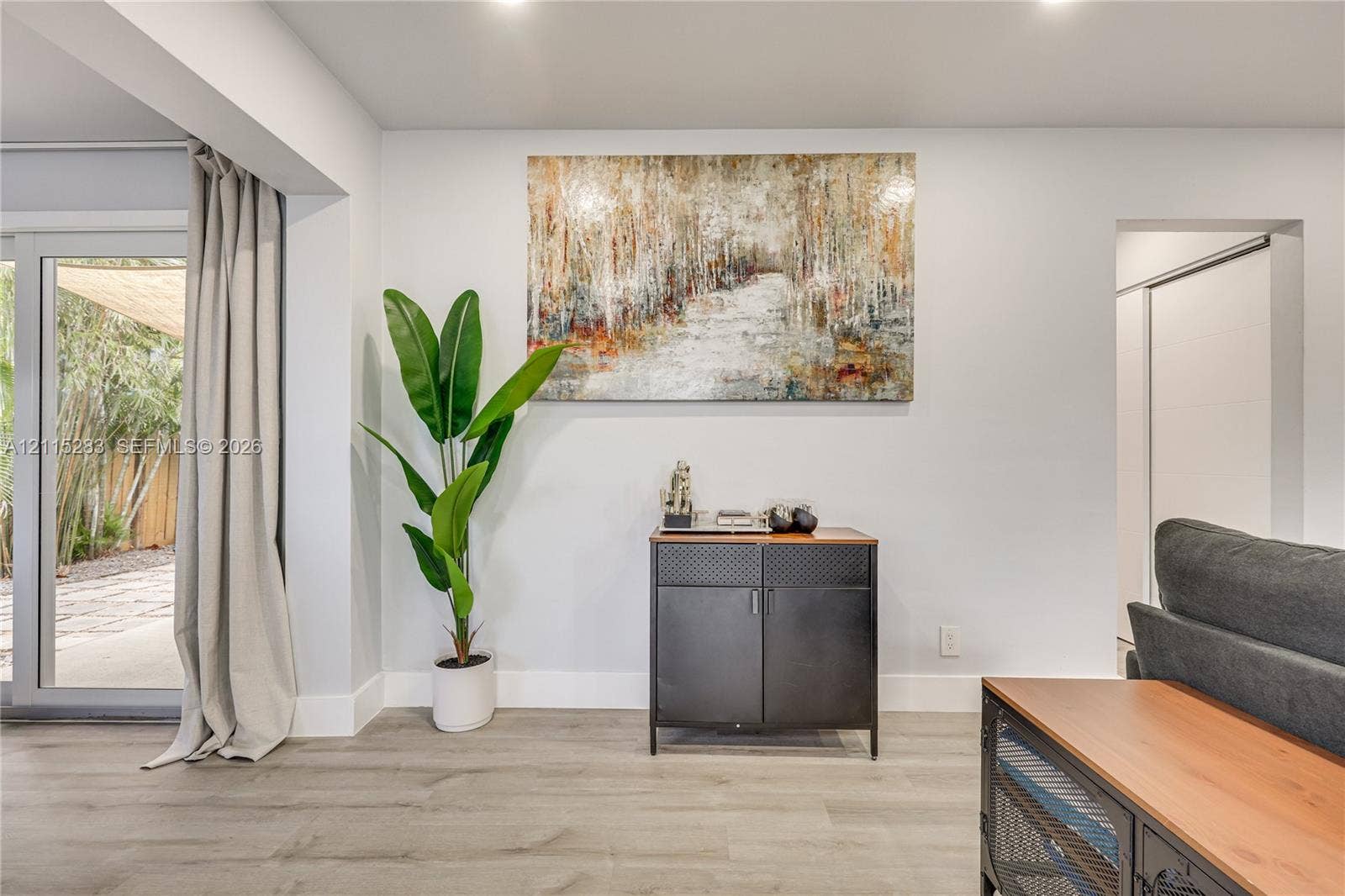 1619a NE 25th Street, #A, Wilton Manors, Wilton Manors, FL 33305 Neutral walls, wood-finish flooring, and recessed lighting, featuring sliding glass doors with outdoor access