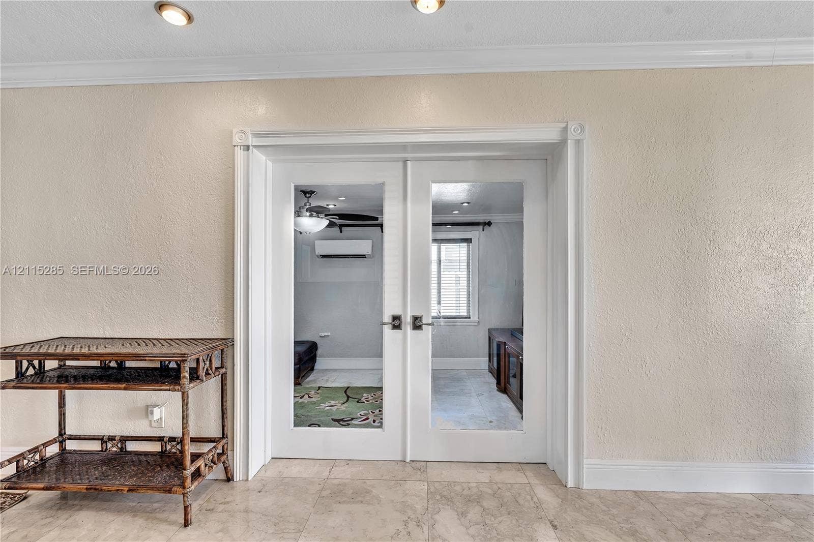 14221 Carver Drive, Miami, FL 33176 White French doors with glass panels, crown molding, stone-finish flooring, and recessed ceiling lighting