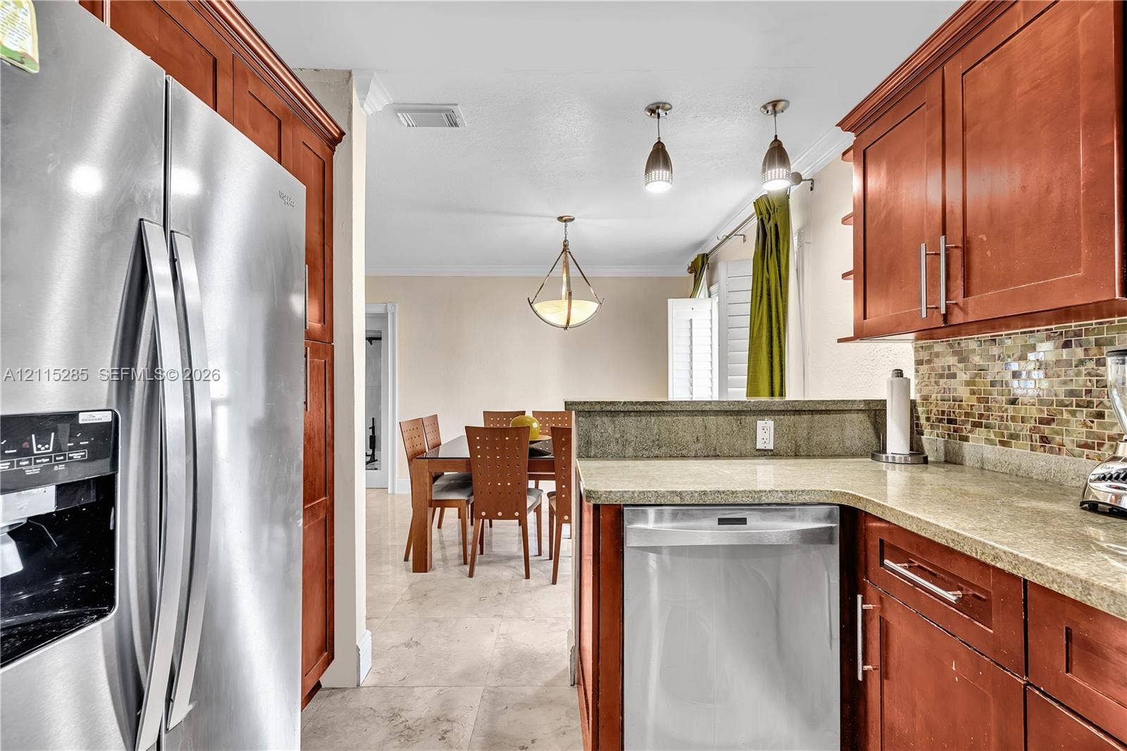 14221 Carver Drive, Miami, FL 33176 Kitchen featuring wood cabinetry, stone countertops, a mosaic tile backsplash, stainless steel appliances, and tile flooring