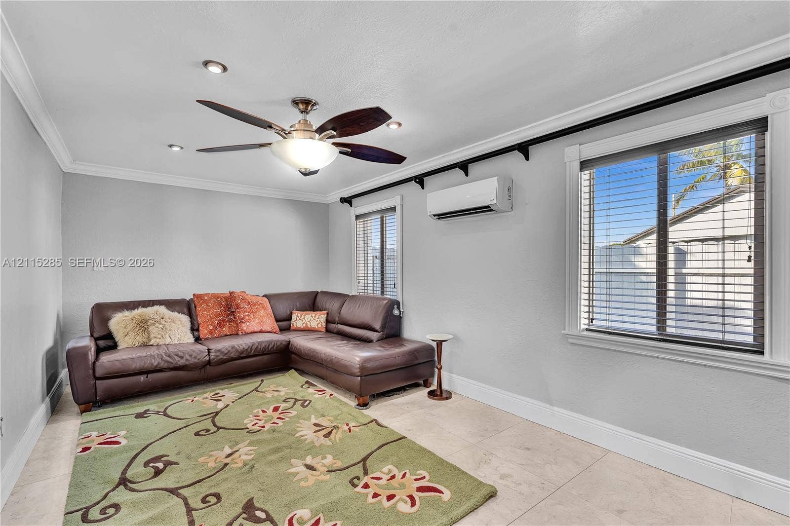 14221 Carver Drive, Miami, FL 33176 Neutral-toned interior space featuring stone-style tile flooring, crown molding, recessed lighting, a multi-blade ceiling fan, and a wall-mounted ductless climate control unit
