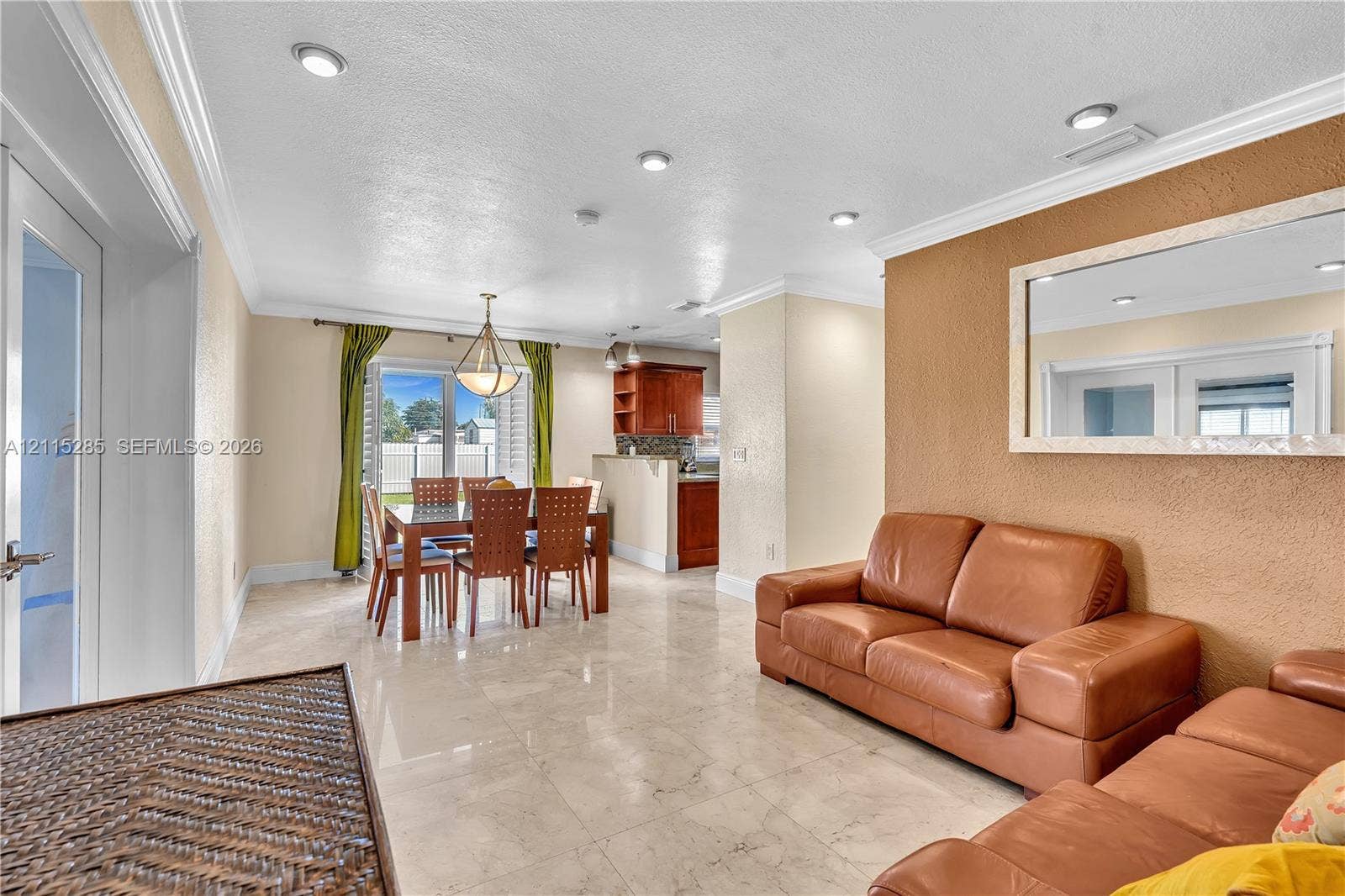 14221 Carver Drive, Miami, FL 33176 Open-concept interior featuring large-format tile flooring, recessed ceiling lighting, crown molding, and a built-in wall mirror