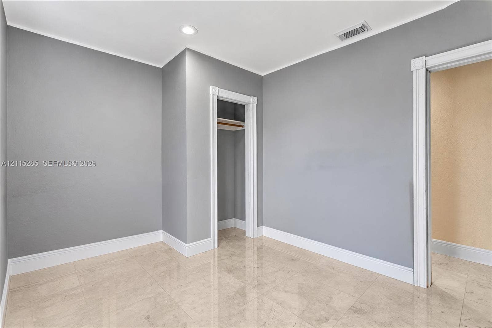 14221 Carver Drive, Miami, FL 33176 Neutral-toned interior featuring stone-finish tile flooring, recessed ceiling lighting, and a closet with built-in shelving