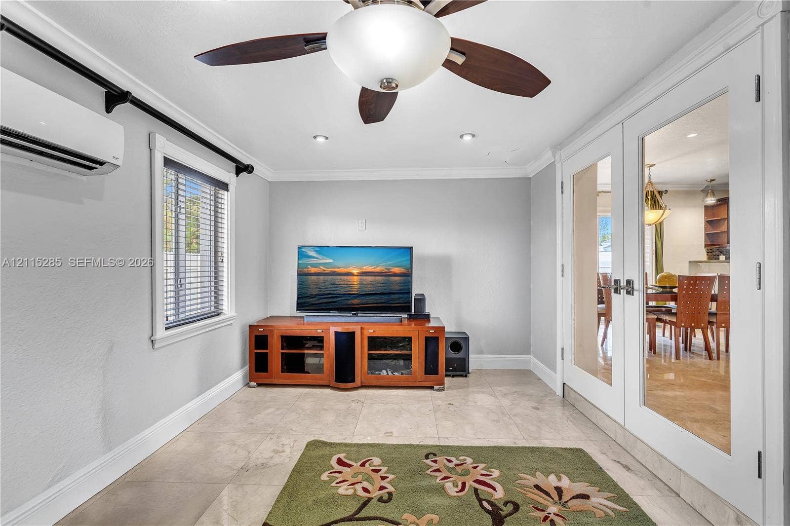 14221 Carver Drive, Miami, FL 33176 Large-format tile flooring, ceiling fan with integrated lighting, wall-mounted climate control unit, and glass-paneled double doors