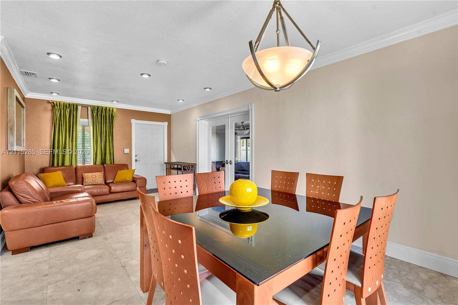 14221 Carver Drive, Miami, FL 33176 Neutral-toned tile flooring, recessed lighting, crown molding, and a geometric-style metal pendant light fixture