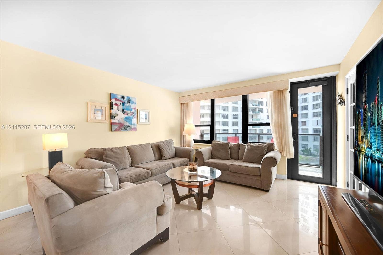 5225 Collins Avenue, #511, Miami Beach, FL 33140 Living area featuring polished tile flooring, floor-to-ceiling windows, and a glass-paned door providing exterior access