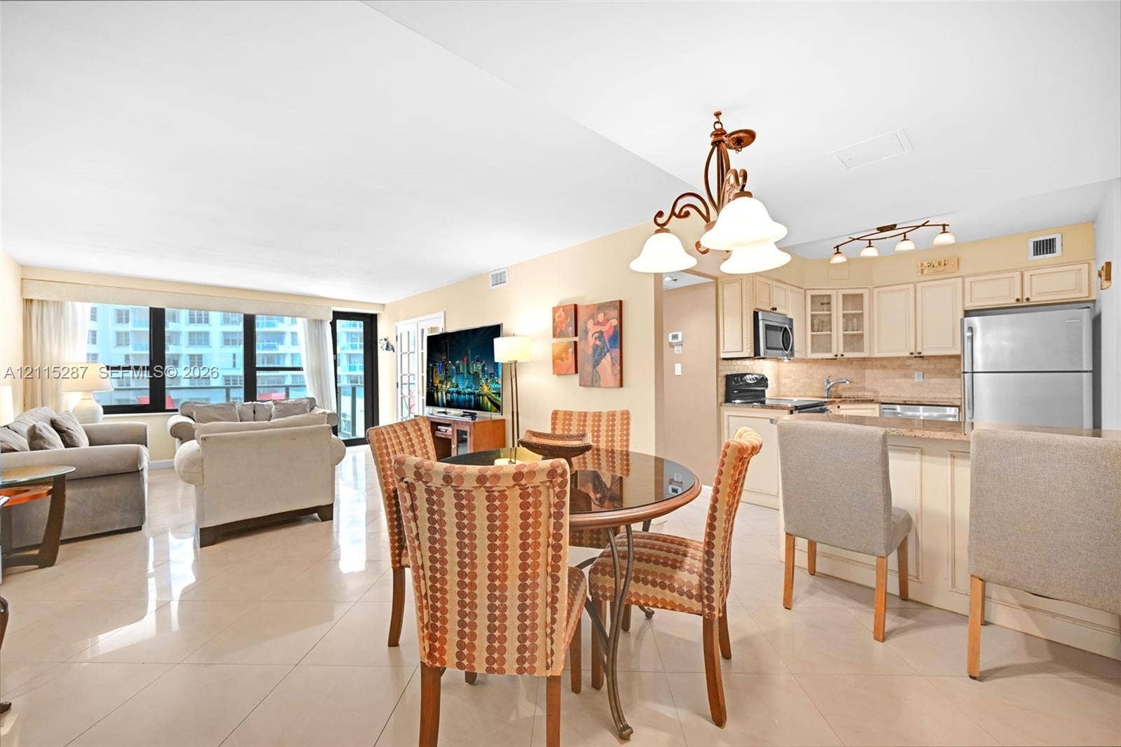 5225 Collins Avenue, #511, Miami Beach, FL 33140 Open-concept interior featuring large-format tile flooring, recessed lighting, and expansive windows