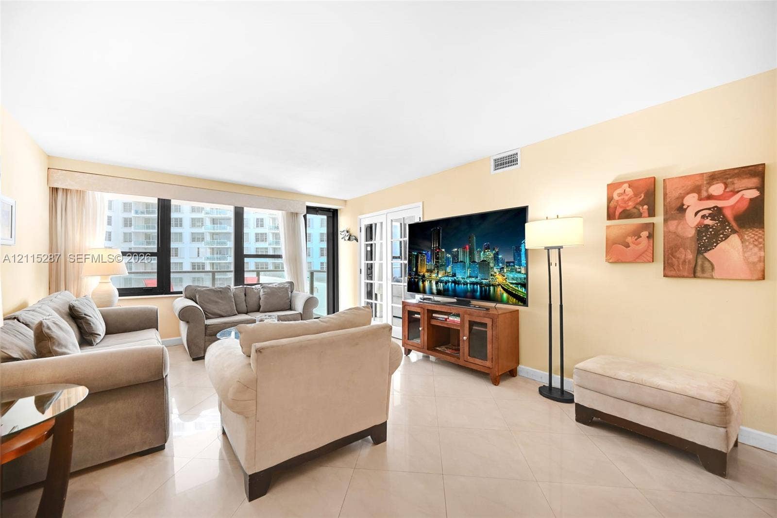 5225 Collins Avenue, #511, Miami Beach, FL 33140 Living area featuring large-format ceramic tile flooring, floor-to-ceiling windows, and glass-paneled patio doors