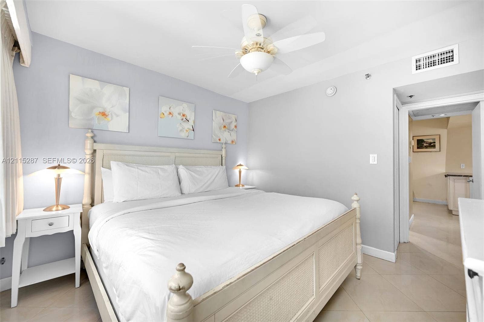 5225 Collins Avenue, #511, Miami Beach, FL 33140 Neutral-toned walls paired with tile flooring, featuring a ceiling-mounted light fixture and fan combination