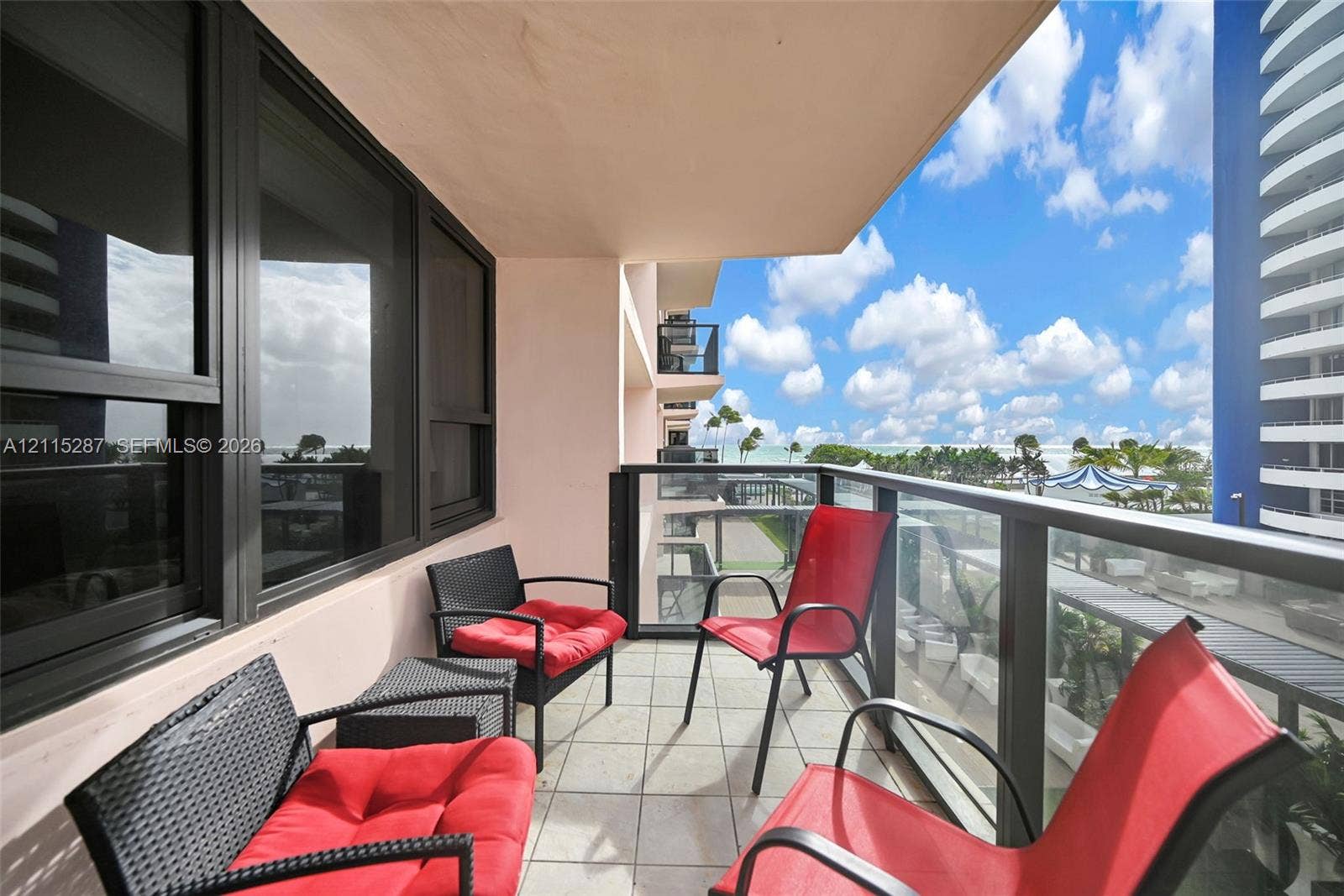 5225 Collins Avenue, #511, Miami Beach, FL 33140 Covered balcony featuring tile flooring and a glass-paneled railing