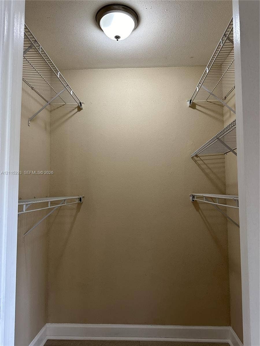2642 NW 33rd Street, #1902, Oakland Park, Oakland Park, FL 33309 Storage space featuring white wire shelving units and a circular dome-style ceiling light fixture