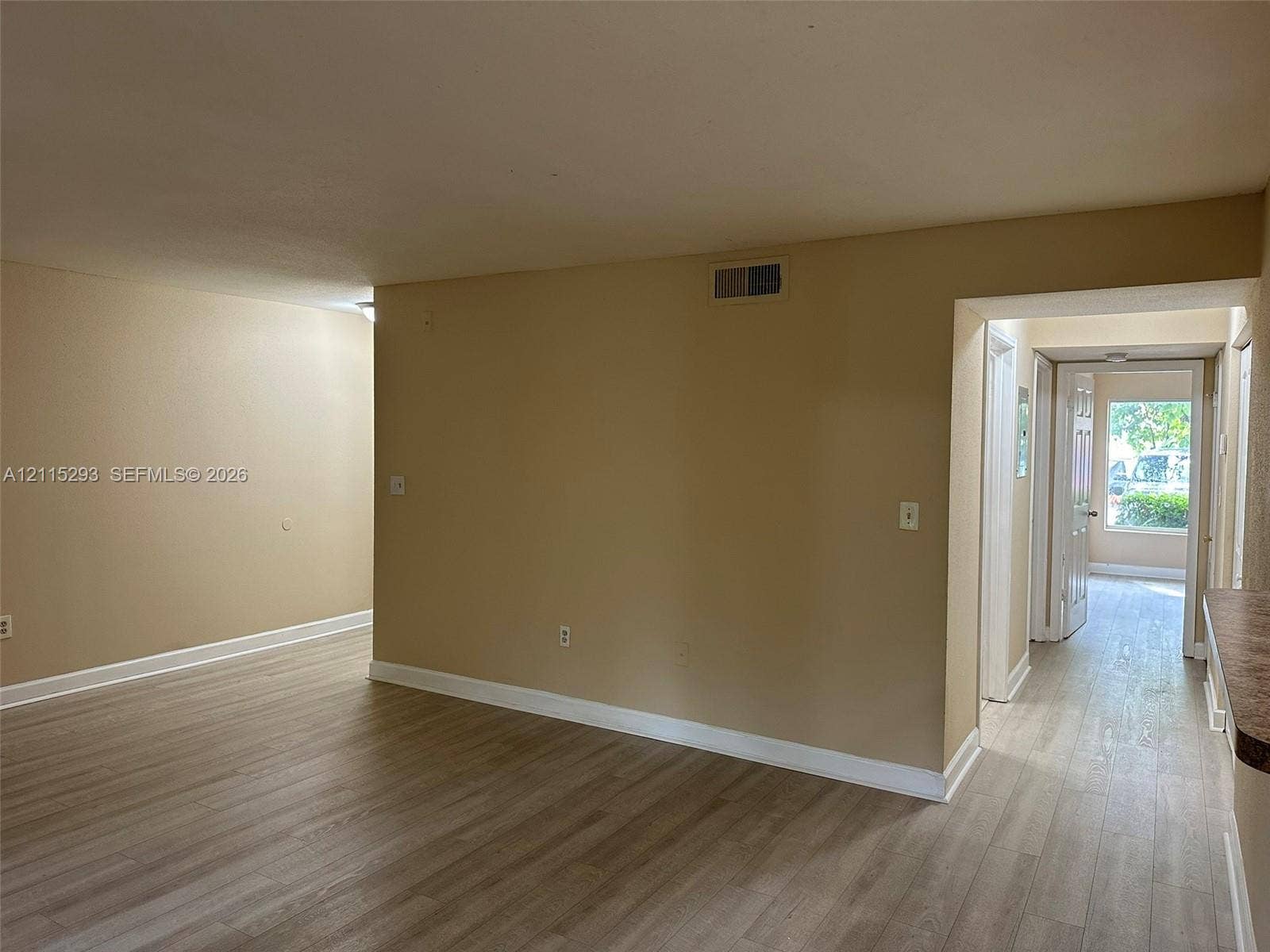 2642 NW 33rd Street, #1902, Oakland Park, Oakland Park, FL 33309 Interior featuring wood-finish flooring, neutral wall paint, and white trim accents