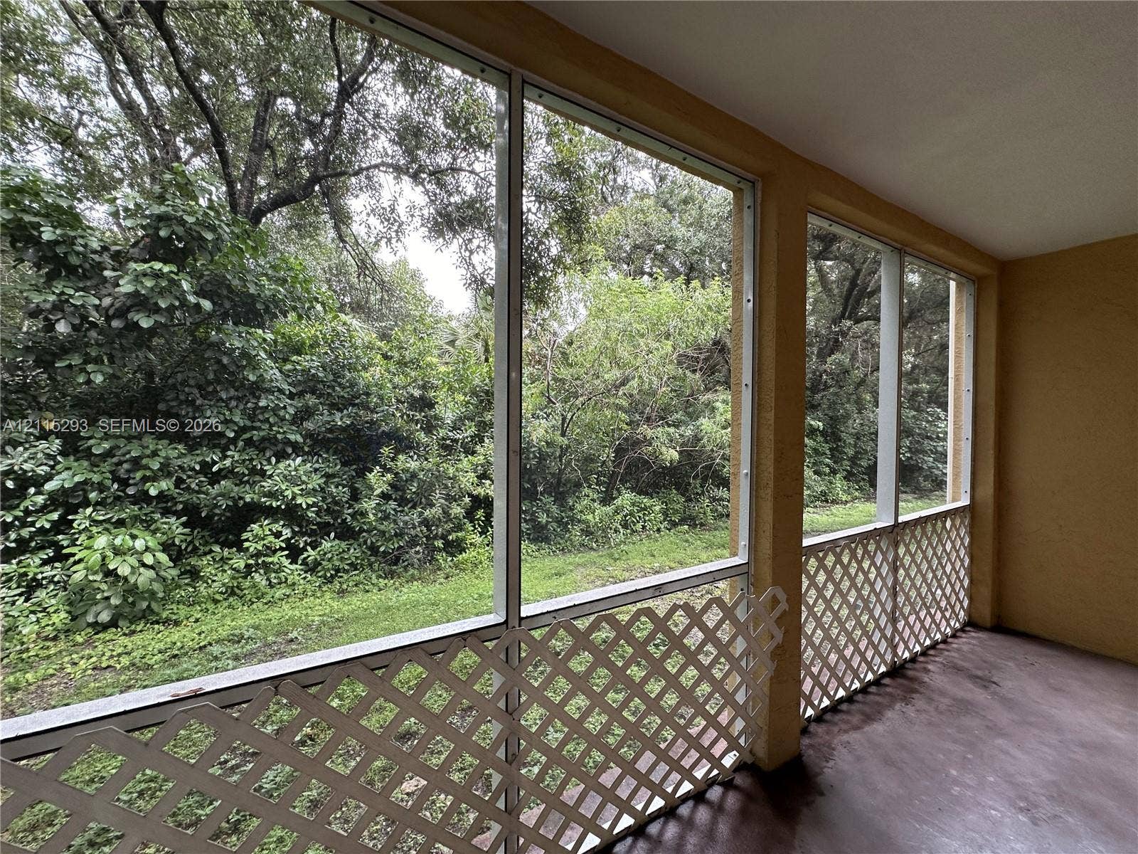 2642 NW 33rd Street, #1902, Oakland Park, Oakland Park, FL 33309 Screened-in porch featuring concrete flooring, full-height window screening, and white lattice decorative panels
