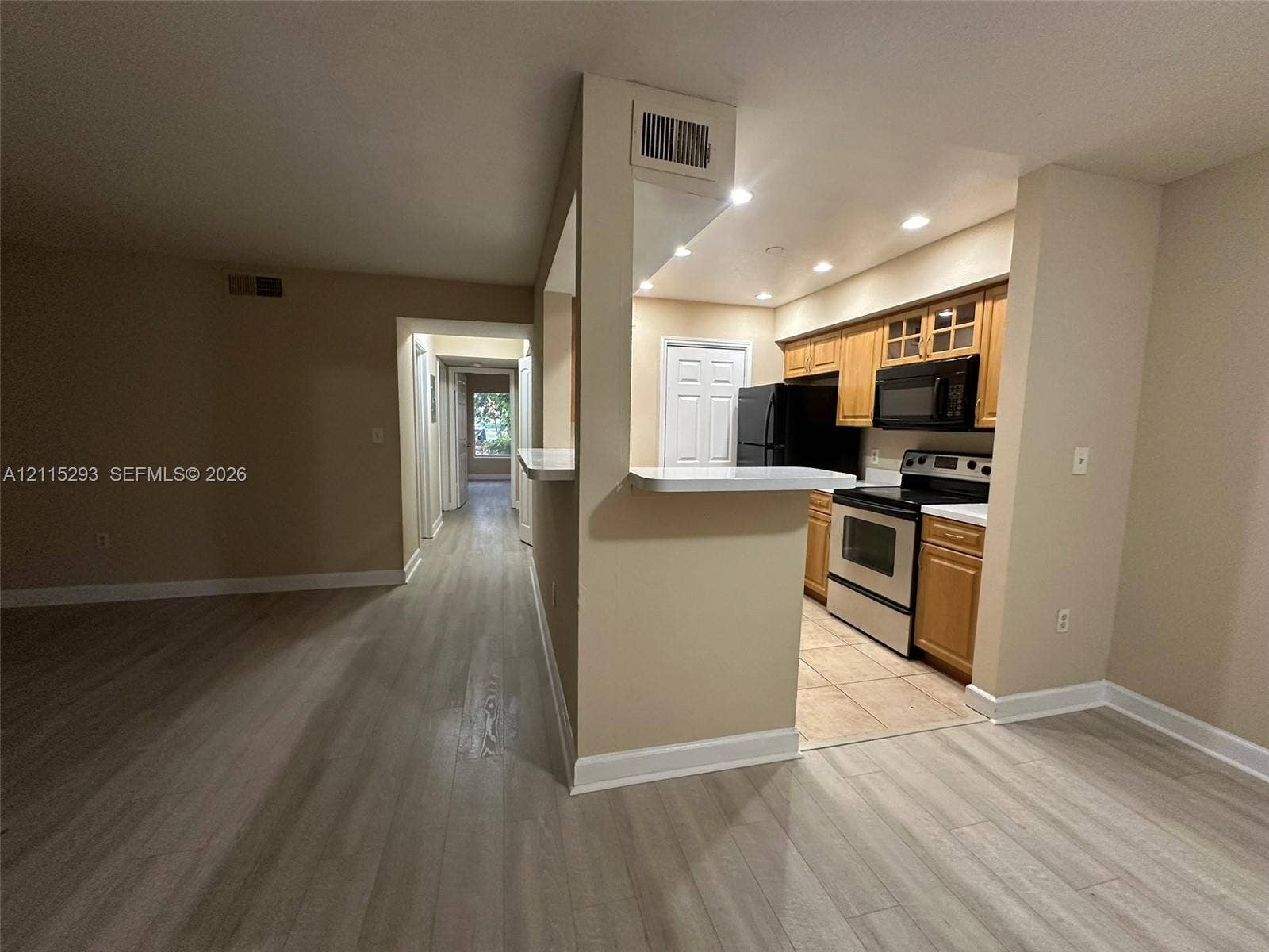 2642 NW 33rd Street, #1902, Oakland Park, Oakland Park, FL 33309 Kitchen featuring wood-finish cabinetry, a breakfast bar, recessed lighting, and tile flooring