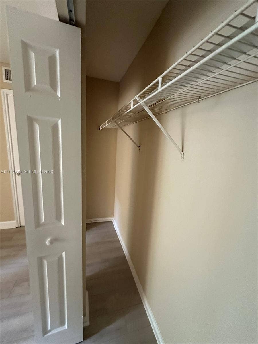 2642 NW 33rd Street, #1902, Oakland Park, Oakland Park, FL 33309 Storage space featuring bi-fold panel doors and wire shelving