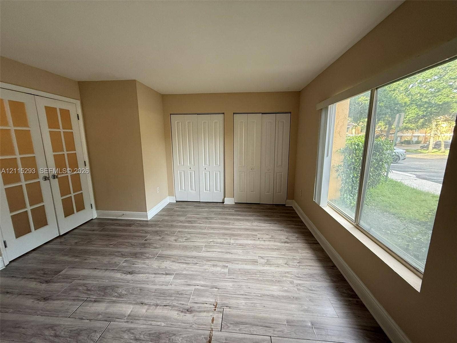 2642 NW 33rd Street, #1902, Oakland Park, Oakland Park, FL 33309 Wood-finish flooring, dual French doors with glass panes, two sets of bi-fold closet doors, and large windows