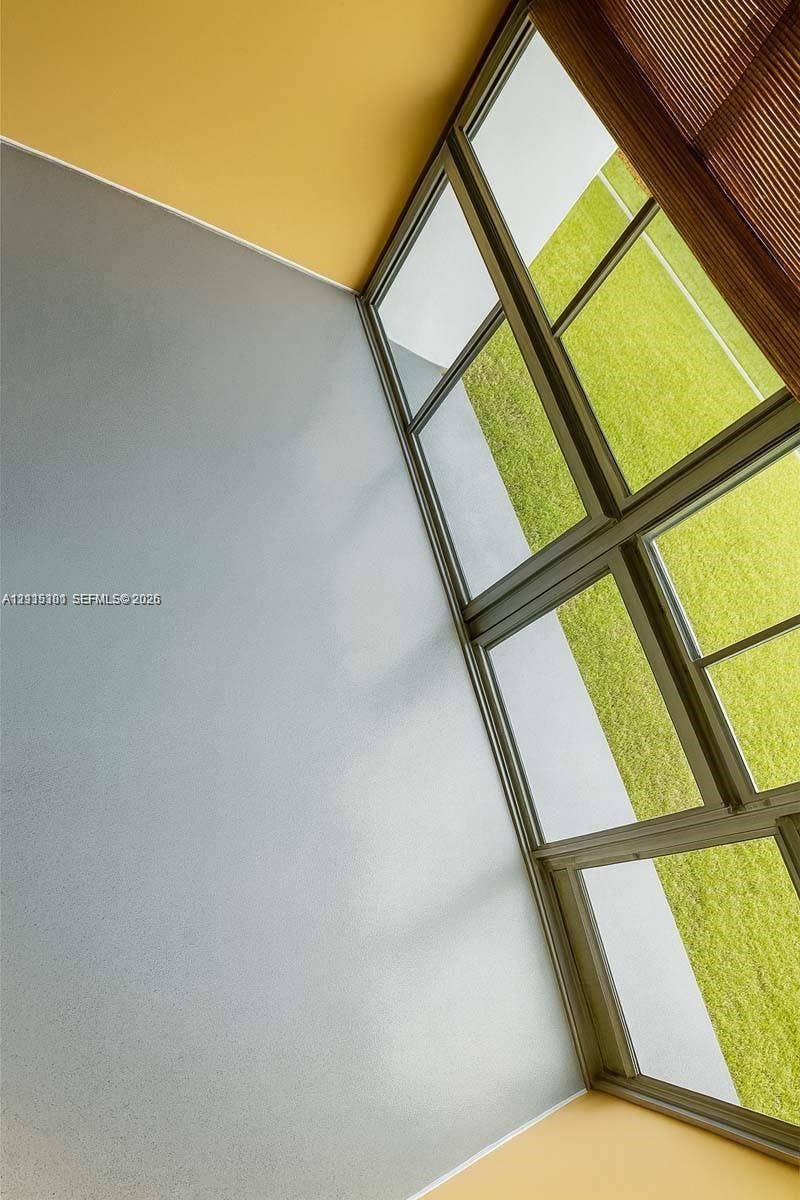 1630 Embassy Drive, #101, West Palm Beach, West Palm Beach, FL 33401 Floor-to-ceiling multi-pane windows with thin metal framing, integrated window treatment, and smooth-finish wall surfaces