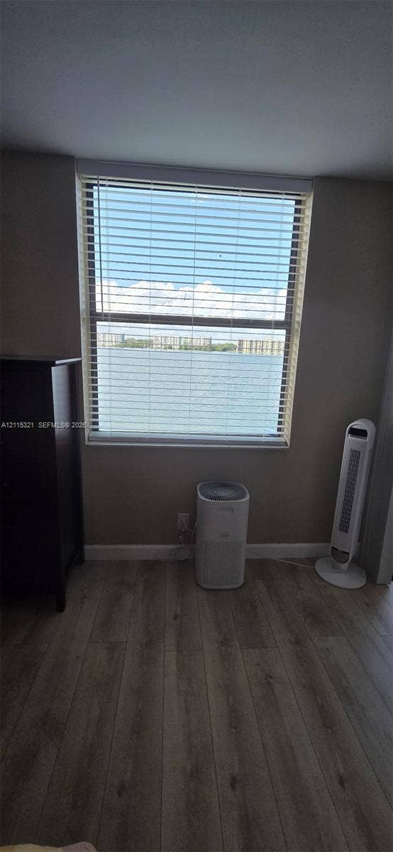 115 Lake Emerald Drive, #408, Oakland Park, FL 33309 Single-pane window with horizontal blinds featuring a water backdrop and wood-finish flooring