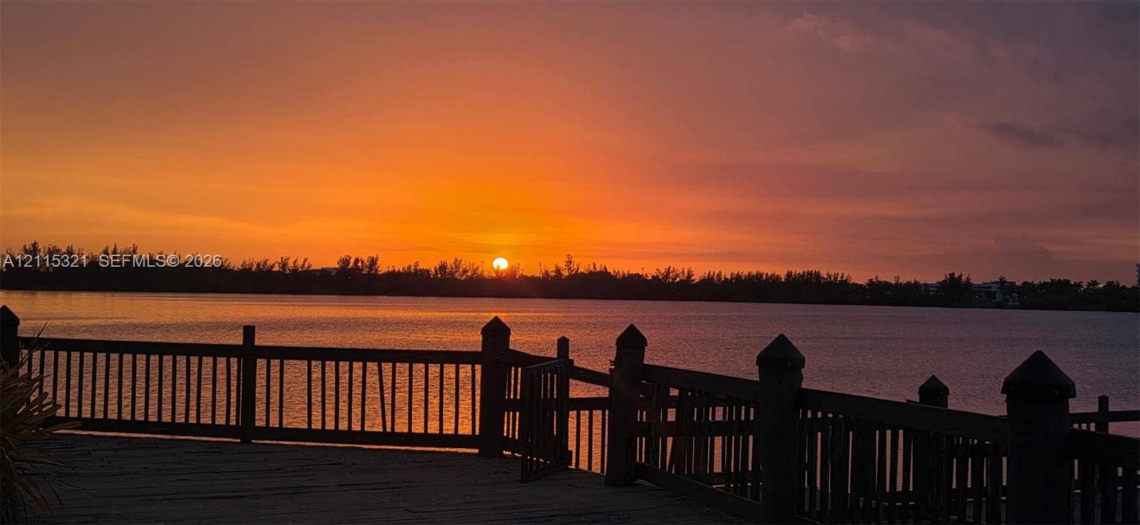 115 Lake Emerald Drive, #408, Oakland Park, FL 33309 Waterfront deck featuring a wood-finished surface, perimeter railing, and a direct water backdrop