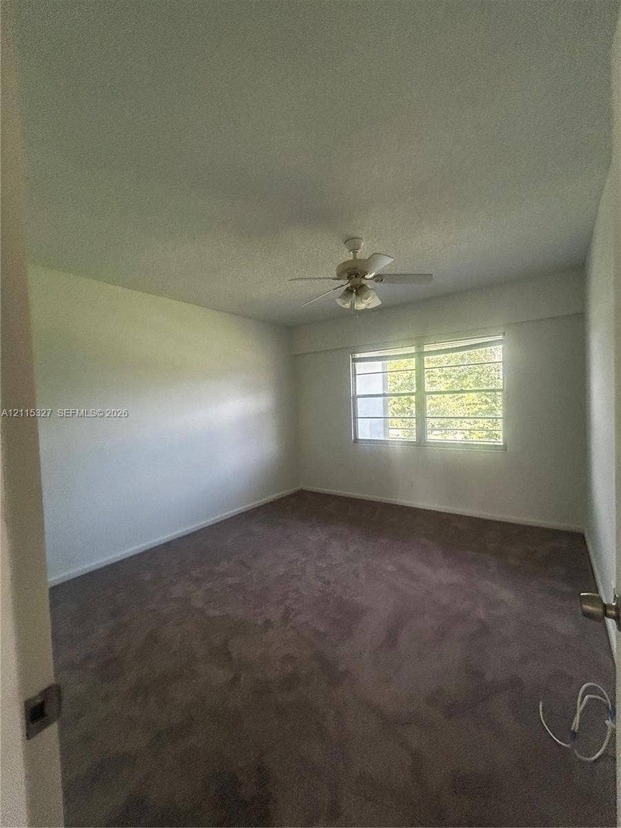 335 Brighton H, #H, Boca Raton, Boca Raton, FL 33434 Neutral-toned carpeting, ceiling-mounted light fixture with fan, and horizontal window blinds