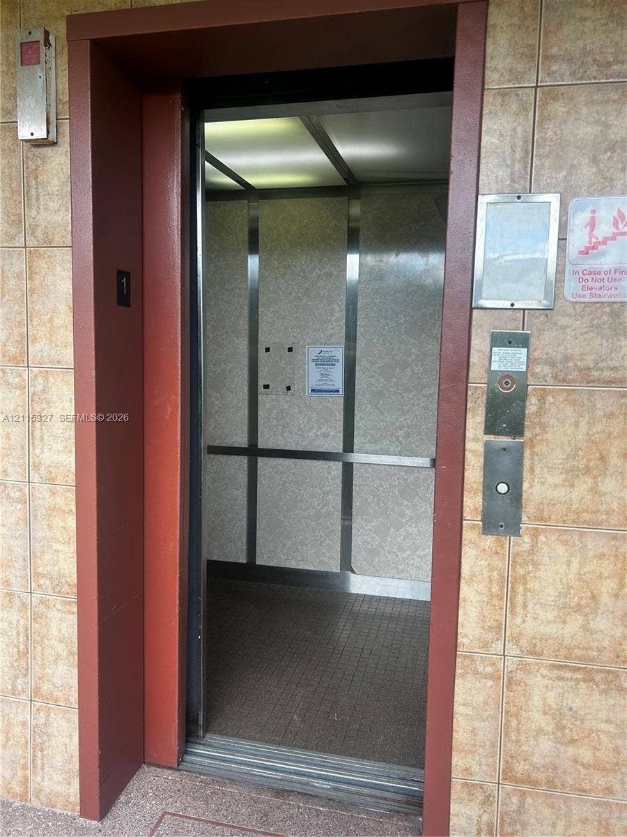 335 Brighton H, #H, Boca Raton, Boca Raton, FL 33434 Elevator featuring brushed metal interior panels, integrated ceiling lighting, and tile-surround entry