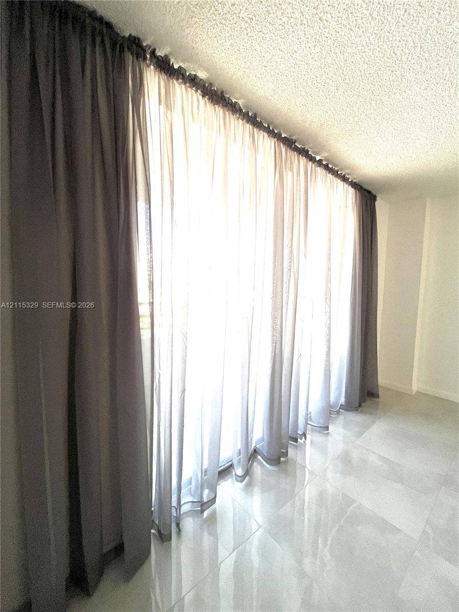 2500 Parkview Drive, #1705, Hallandale Beach, Hallandale Beach, FL 33009 Large-format glass sliding door system with floor-to-ceiling profile and polished light-toned tile flooring