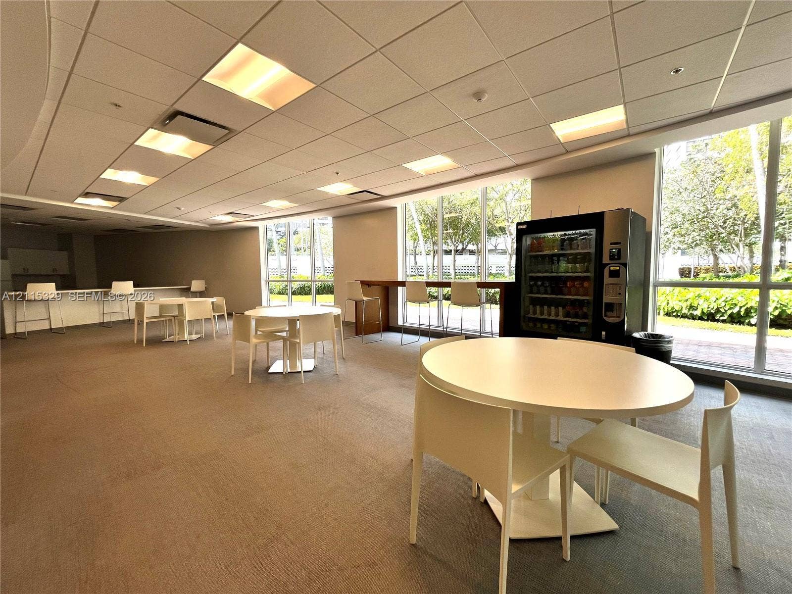 2500 Parkview Drive, #1705, Hallandale Beach, Hallandale Beach, FL 33009 Open-concept space featuring floor-to-ceiling windows, drop-tile ceiling with recessed lighting, and neutral carpeting