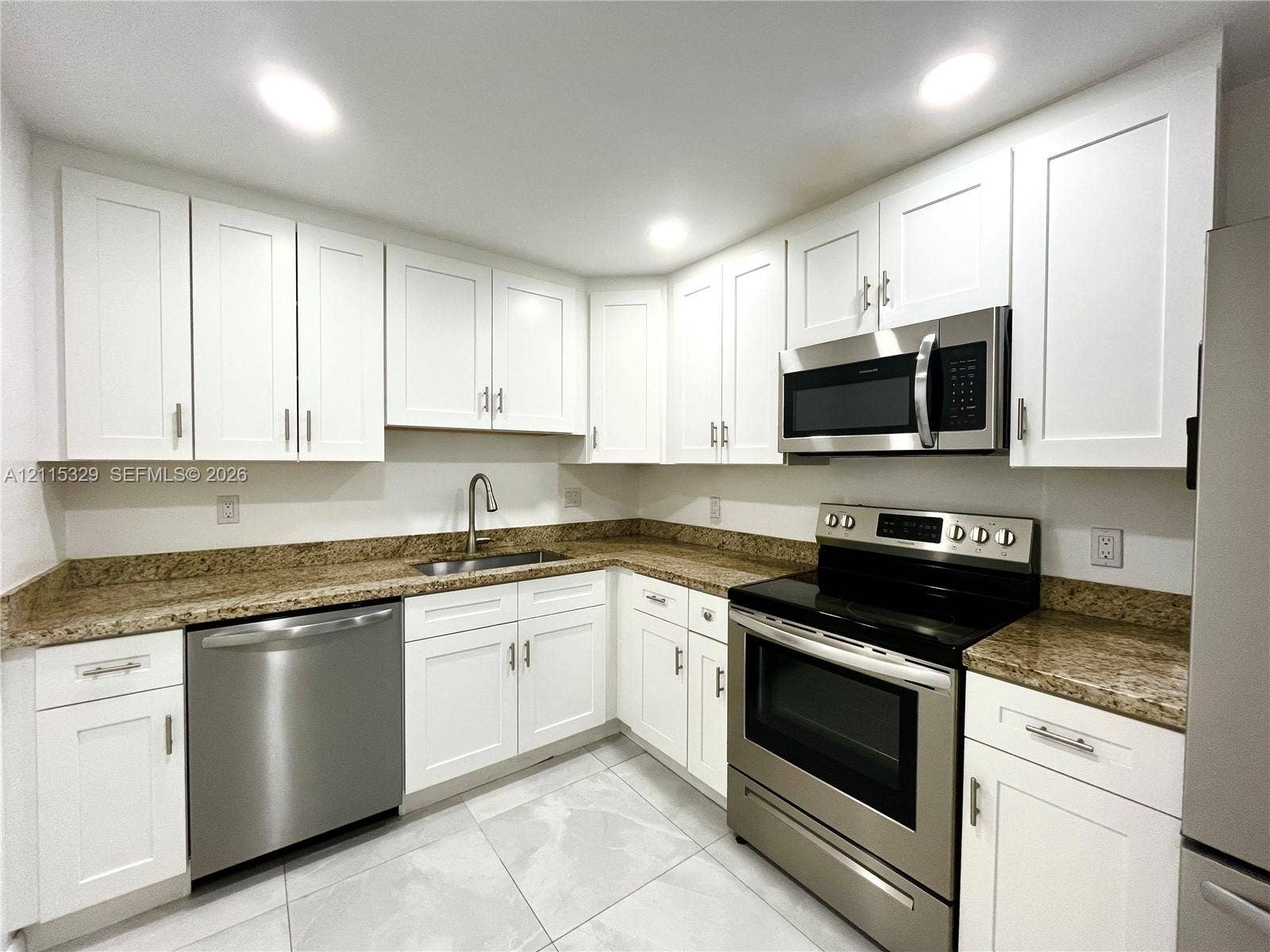 2500 Parkview Drive, #1705, Hallandale Beach, Hallandale Beach, FL 33009 Kitchen featuring white shaker-style cabinetry, stone countertops, stainless steel appliances, and large-format tile flooring