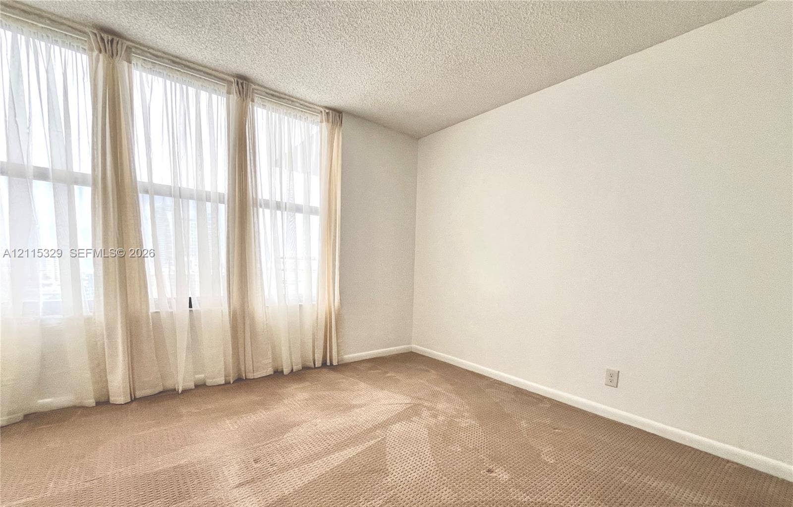 2500 Parkview Drive, #1705, Hallandale Beach, Hallandale Beach, FL 33009 Floor-to-ceiling windows feathering window curtains and neutral carpeting