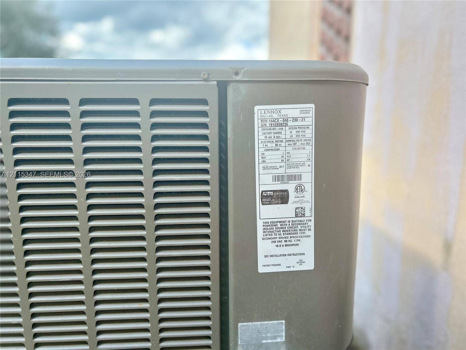 Lennox air conditioning unit featuring an exterior-grade metallic housing, industrial ventilation grilles, and a standardized equipment identification panel