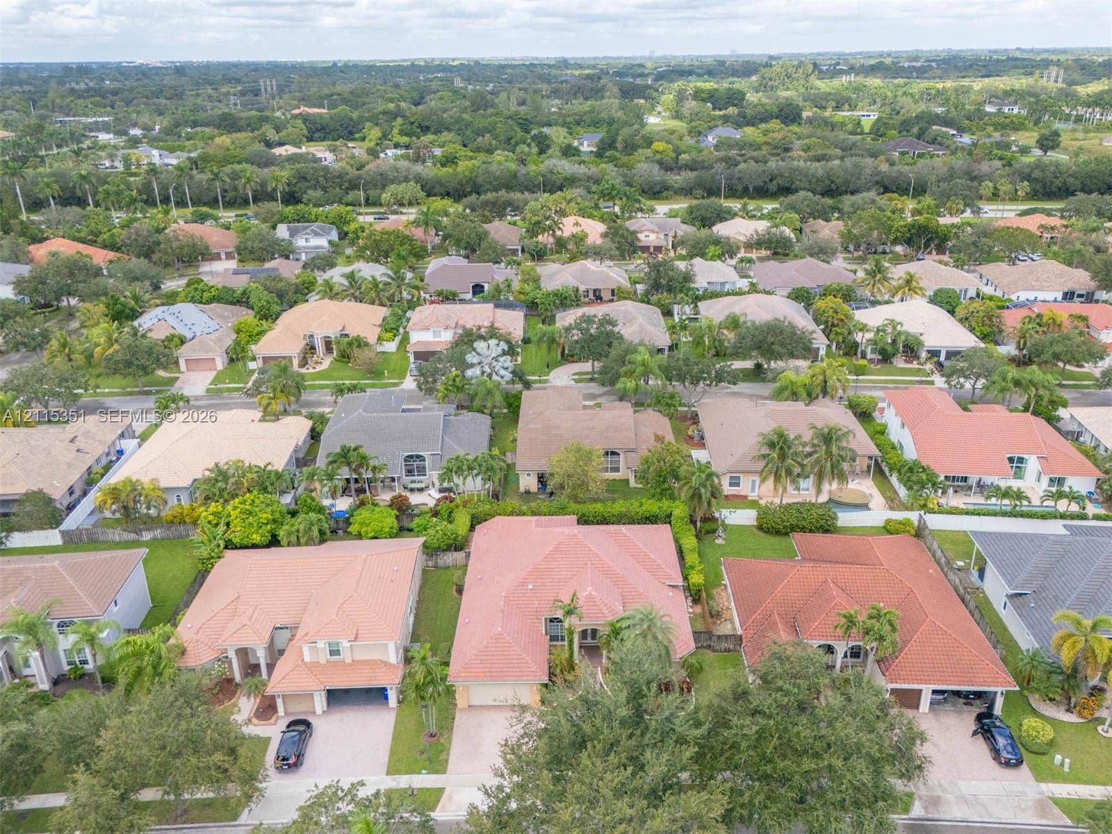 13845 NW 20th Street, Pembroke Pines, FL 33028 Aerial perspective of a residential neighborhood featuring paved streets, mature landscaping, varied tile roofing, and concrete driveways