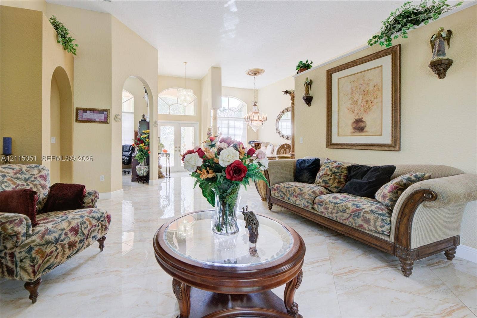 13845 NW 20th Street, Pembroke Pines, FL 33028 Open-concept interior featuring high ceilings, arched architectural entries, polished tile flooring, and multiple pendant light fixtures