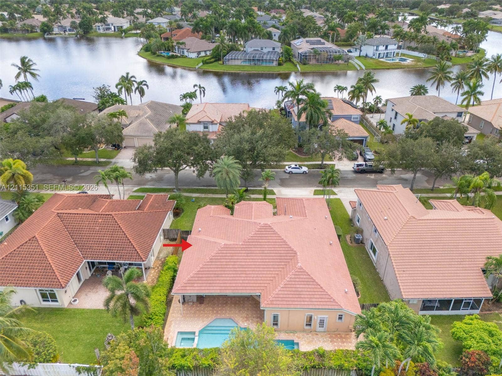 13845 NW 20th Street, Pembroke Pines, FL 33028 Aerial view featuring a tile roof, private swimming pool, paved rear patio, and water frontage