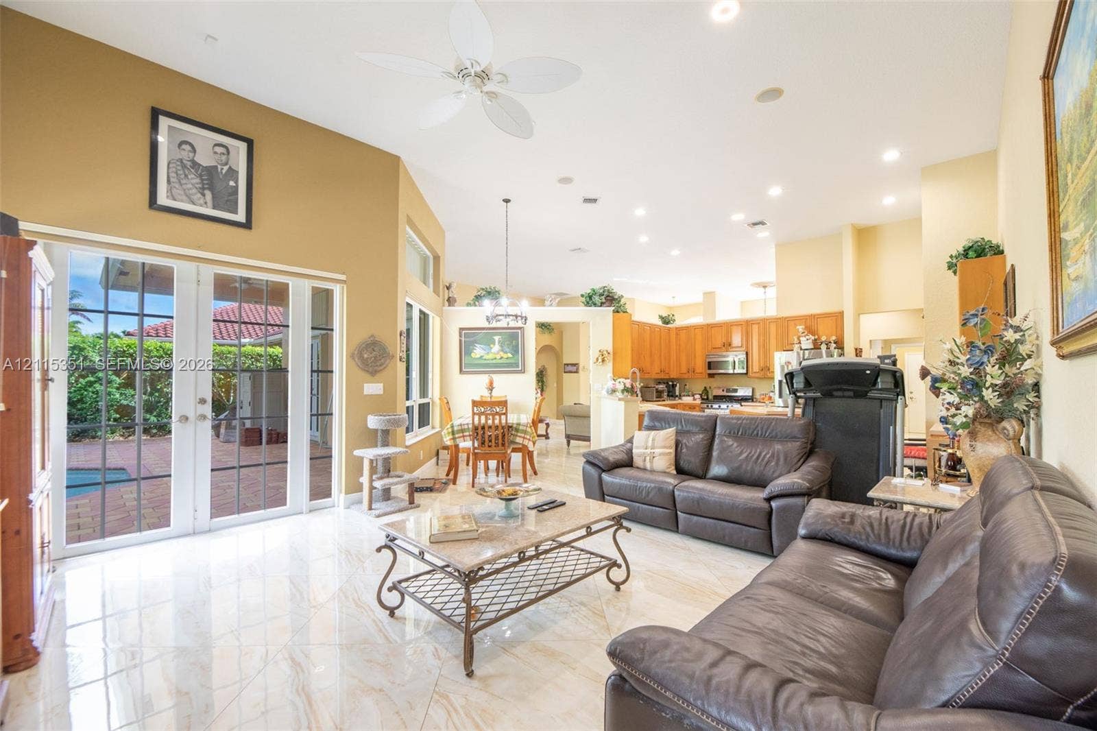 13845 NW 20th Street, Pembroke Pines, FL 33028 Vaulted ceilings with recessed lighting, tile flooring, and glass-paned double doors leading to a patio area
