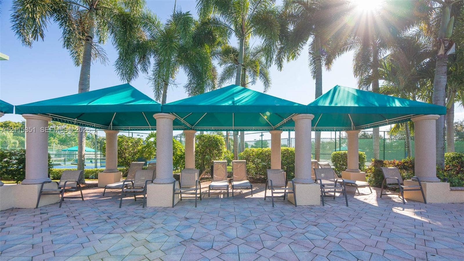 13845 NW 20th Street, Pembroke Pines, FL 33028 Outdoor covered lounge area featuring permanent fabric canopies, structural columns, and paved hardscaping