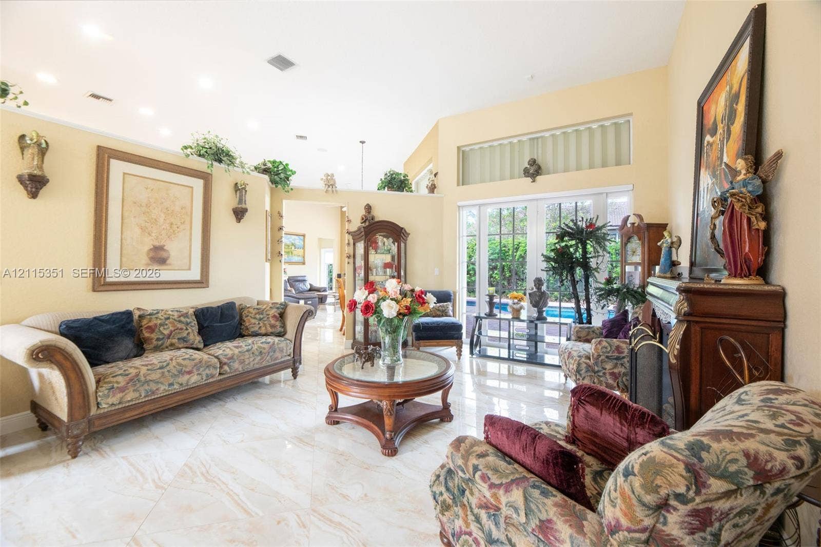 13845 NW 20th Street, Pembroke Pines, FL 33028 Vaulted ceilings, polished tile flooring, recessed lighting, fireplace with a carved mantle, and sliding glass doors