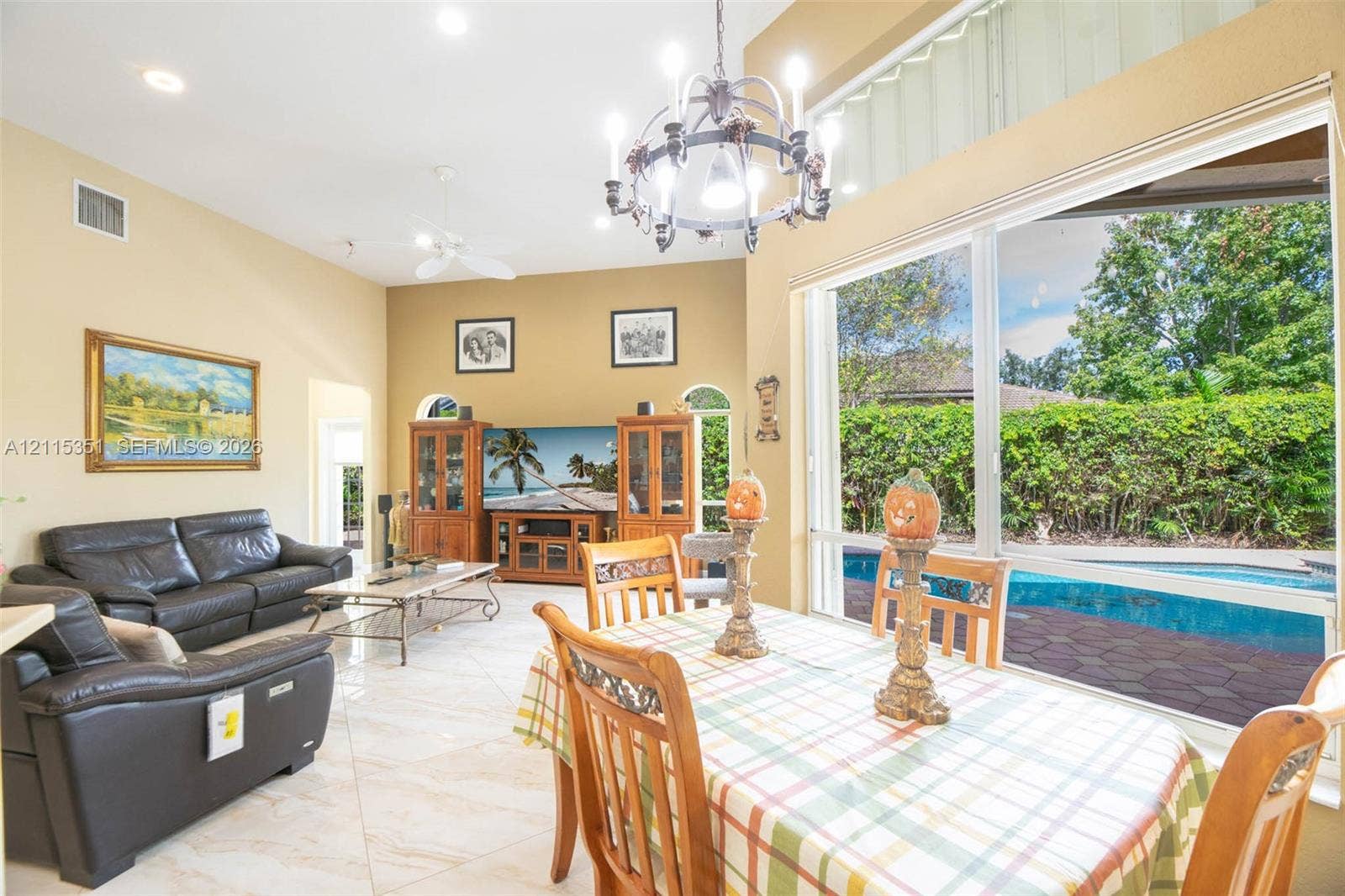 13845 NW 20th Street, Pembroke Pines, FL 33028 Vaulted ceilings, large-format tile flooring, oversized picture windows, and a multi-arm chandelier