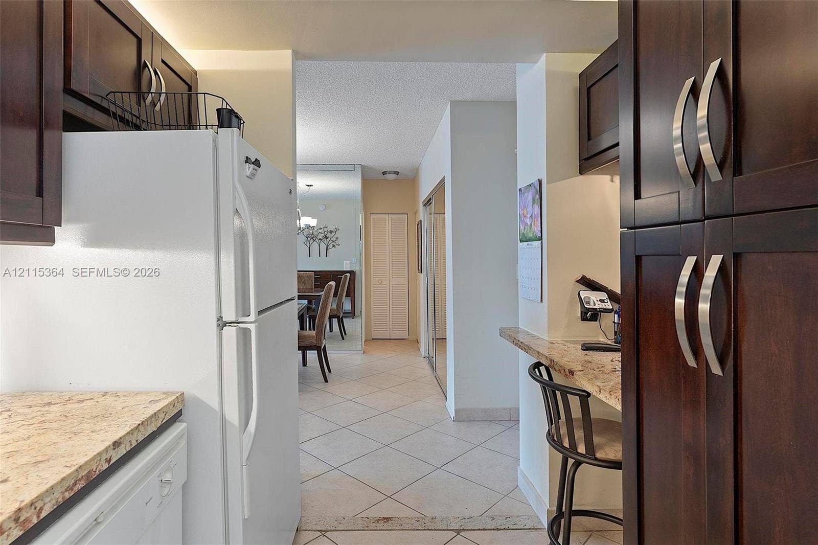 1980 S Ocean Drive, #20A, Hallandale Beach, Hallandale Beach, FL 33009 Dark wood cabinetry, stone-finish countertops, breakfast bar, and tile flooring