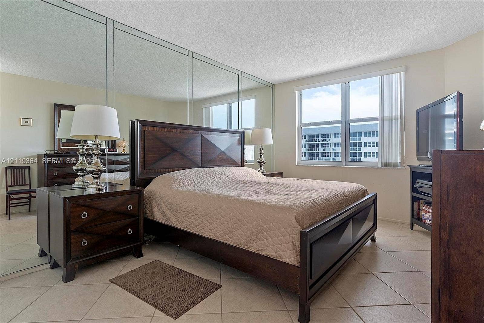 1980 S Ocean Drive, #20A, Hallandale Beach, Hallandale Beach, FL 33009 Wall-to-wall mirrored paneling, tile flooring, and large windows with integrated vertical blinds