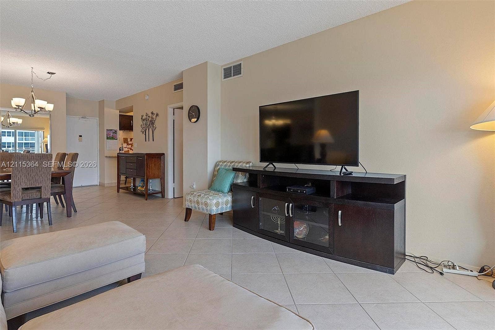 1980 S Ocean Drive, #20A, Hallandale Beach, Hallandale Beach, FL 33009 Neutral-toned interior space featuring light-colored diagonal floor tile and a multi-arm suspended chandelier