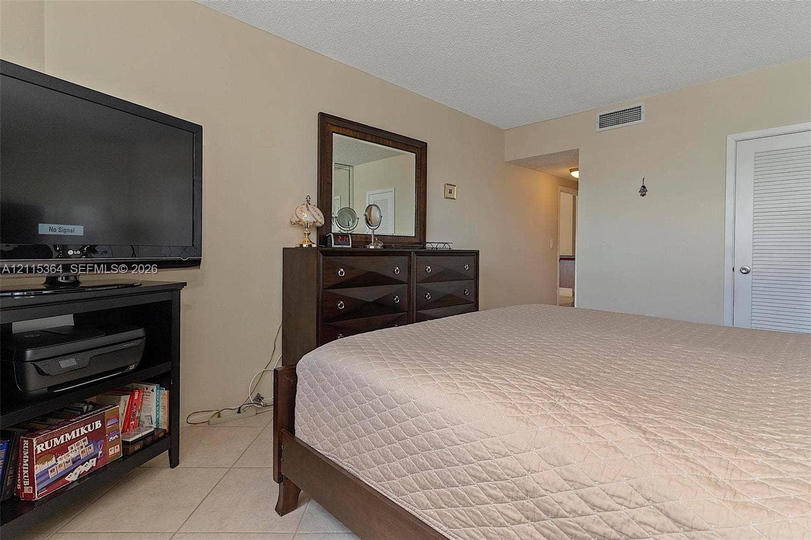 1980 S Ocean Drive, #20A, Hallandale Beach, Hallandale Beach, FL 33009 Neutral-toned walls, light-colored tile flooring, and a louvered closet door
