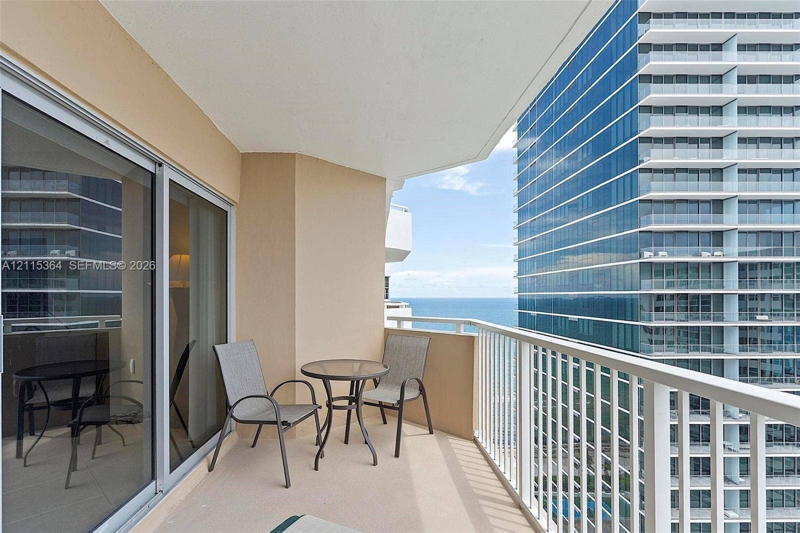 1980 S Ocean Drive, #20A, Hallandale Beach, Hallandale Beach, FL 33009 Private balcony featuring white metal railings, concrete flooring, and sliding glass door entry
