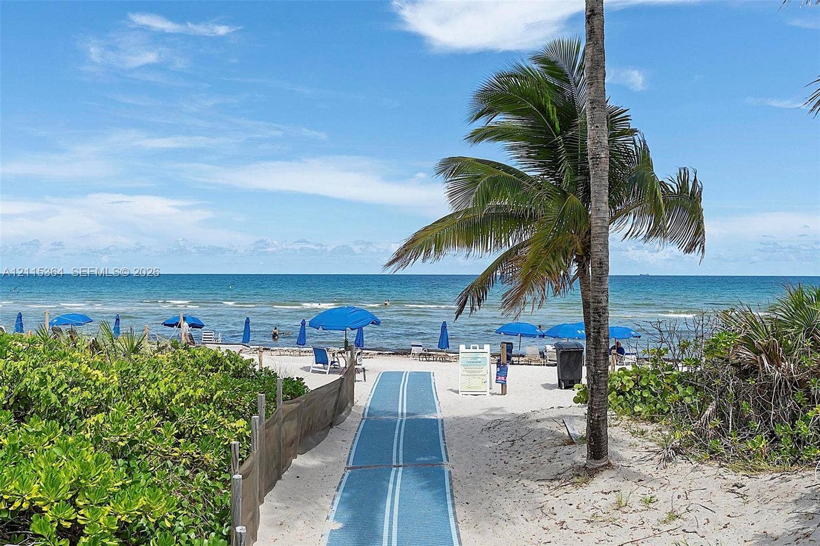 1980 S Ocean Drive, #20A, Hallandale Beach, Hallandale Beach, FL 33009 Beachfront access featuring a direct sandy path, sand-dune vegetation, and mature palm trees