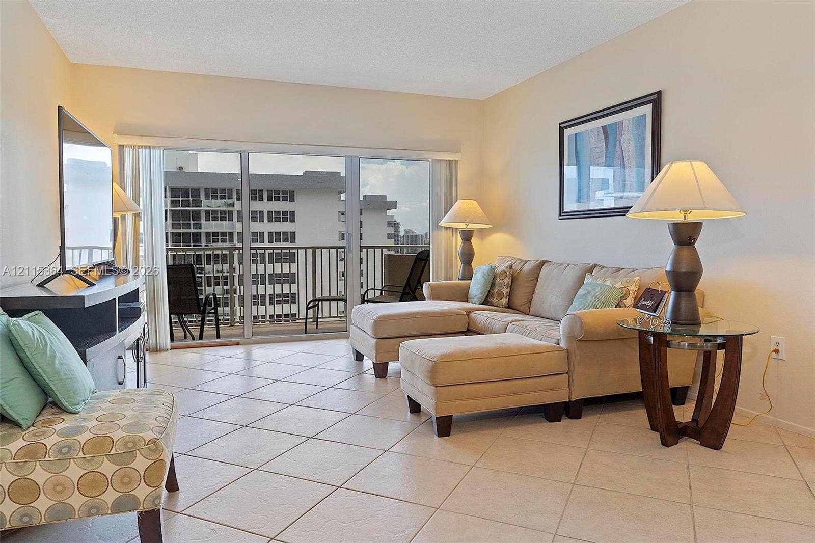 1980 S Ocean Drive, #20A, Hallandale Beach, Hallandale Beach, FL 33009 Ceramic tile flooring, neutral wall tones, and large sliding glass doors opening to a private balcony with metal railings
