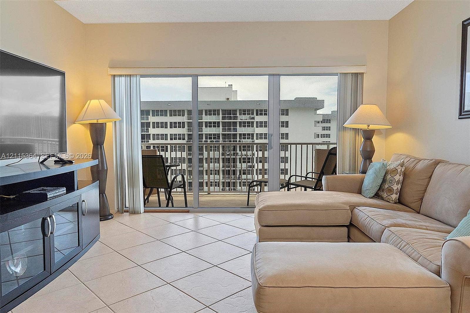 1980 S Ocean Drive, #20A, Hallandale Beach, Hallandale Beach, FL 33009 Neutral-toned ceramic tile flooring, sliding glass doors, and a private balcony featuring a metal railing