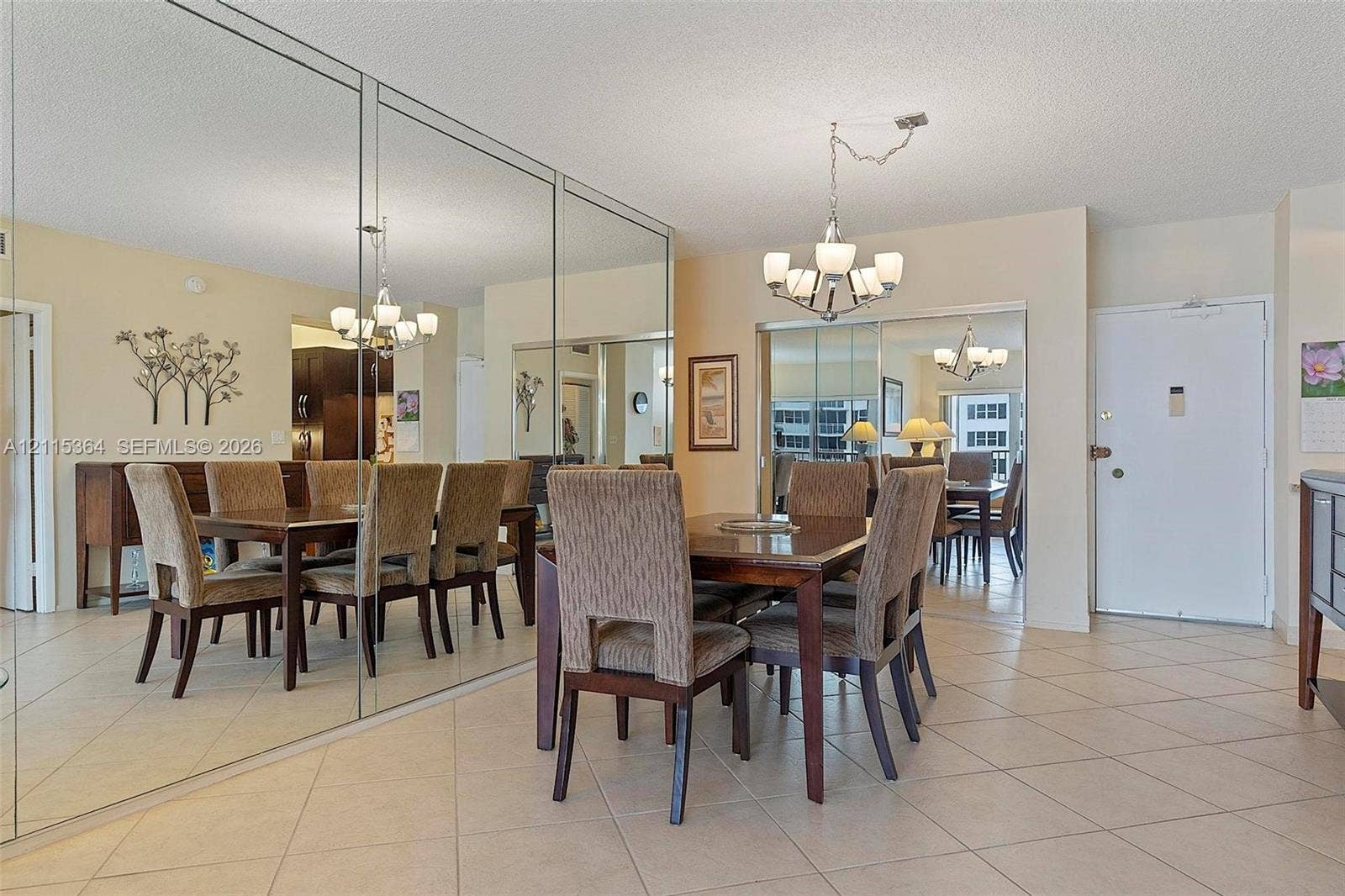 1980 S Ocean Drive, #20A, Hallandale Beach, Hallandale Beach, FL 33009 Floor-to-ceiling wall mirror, neutral tile flooring, and multi-light chandelier fixture